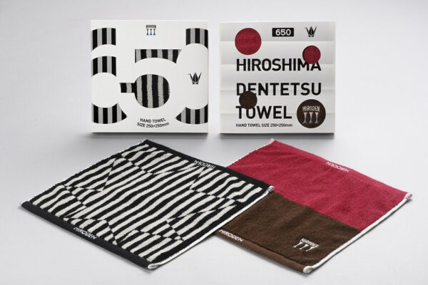Showcase of two distinct package designs and two variations of the HIROSHIMA DENTETSU TOWEL.