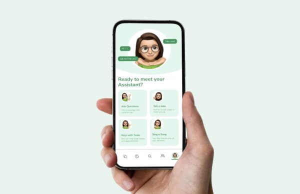 A hand holding a mobile phone showing the HEAR ME app interface for interacting with the virtual assistant