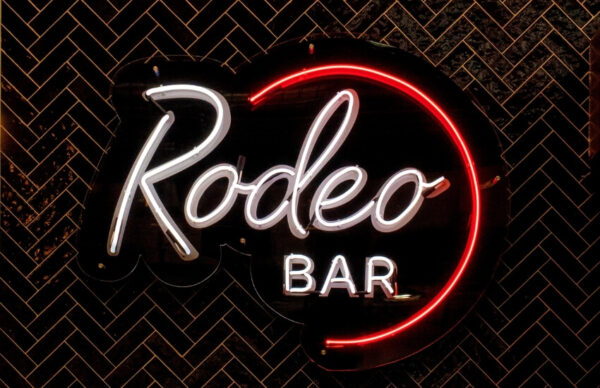 Rodeo 39 logo and neon sign displayed on an interior wall
