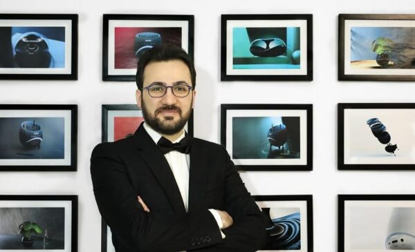 C2A Juror Arvin Maleki standing confidently amidst his creations